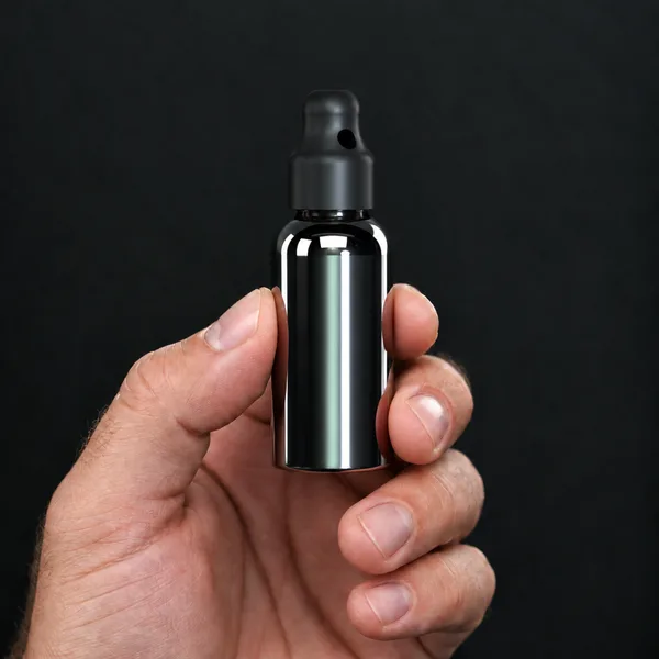 Hand holding a 30 ml silver Boston bottle with a SN*F X-Small sniffer cap